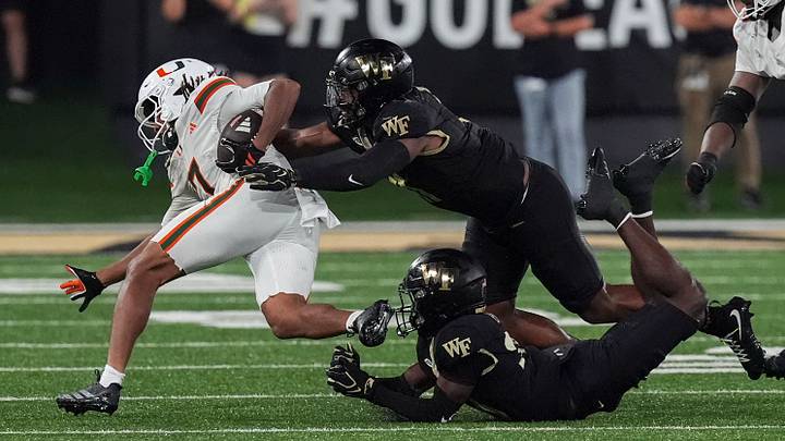 Sep 18, 2026; Winston-Salem, North Carolina, USA; Miami (FL) Hurricanes wide receiver Daylyn Upshaw (7) holds onto the ball challenged by Wake Forest Demon Deacons linebacker Langston Hardy (11) during the second half at Allegacy Federal Credit Union Stadium. Mandatory Credit: Jim Dedmon-Imagn Images Sep 18, 2026; Winston-Salem, North Carolina, USA; Miami (FL) Hurricanes wide receiver Daylyn Upshaw (7) holds onto the ball challenged by Wake Forest Demon Deacons linebacker Langston Hardy (11) during the second half at Allegacy Federal Credit Union Stadium. Mandatory Credit: Jim Dedmon-Imagn Images