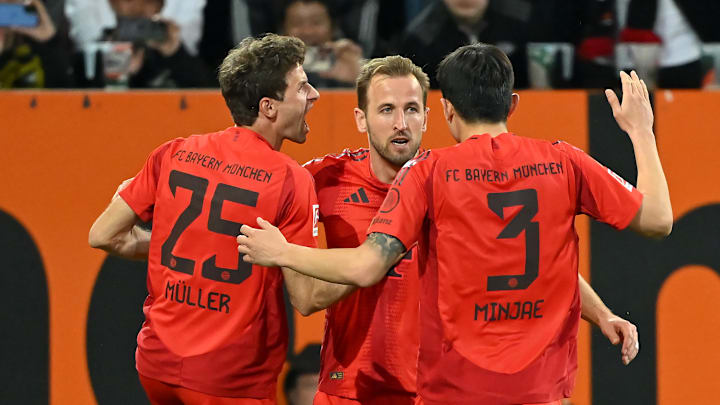 Bayern Munich players celebrating against Augsburg.