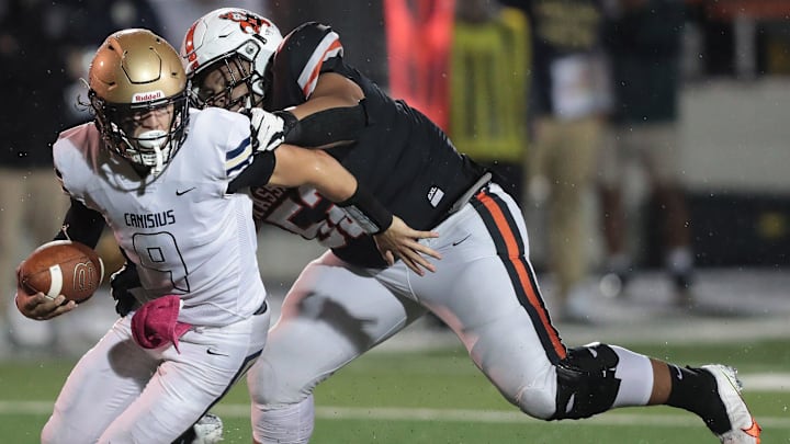 Massillon defensive lineman Marcus Moore sacks Canisius quarterback Tyler Baker in the second half at Massillon.

Massillon Canisius Fball1797