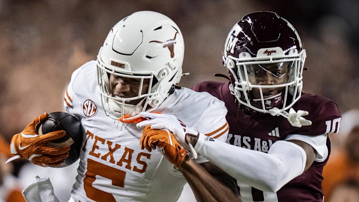 Texas Longhorns wide receiver Ryan Wingo carries the ball against Texas A&M Aggies defensive back Dezz Ricks in the second quarter of the Lone Star Showdown game at Kyle Field.