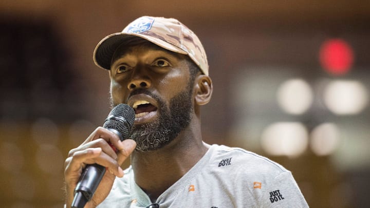 Randy Moss speaks during a charity basketball game.