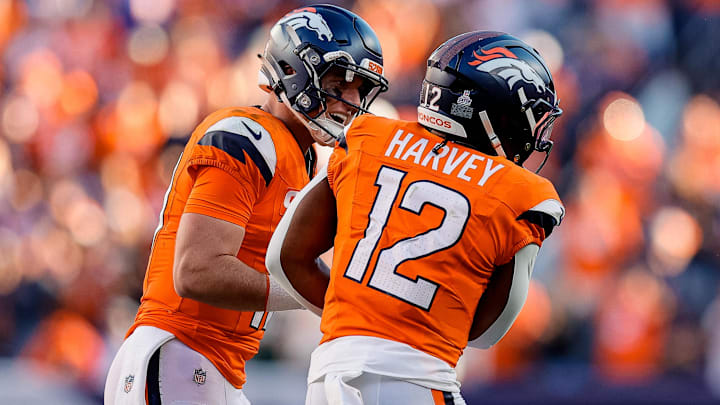 Oct 19, 2025; Denver, Colorado, USA; Denver Broncos quarterback Bo Nix (10) celebrates the touchdown of running back RJ Harvey (12) in the fourth quarter against the New York Giants at Empower Field at Mile High.  
