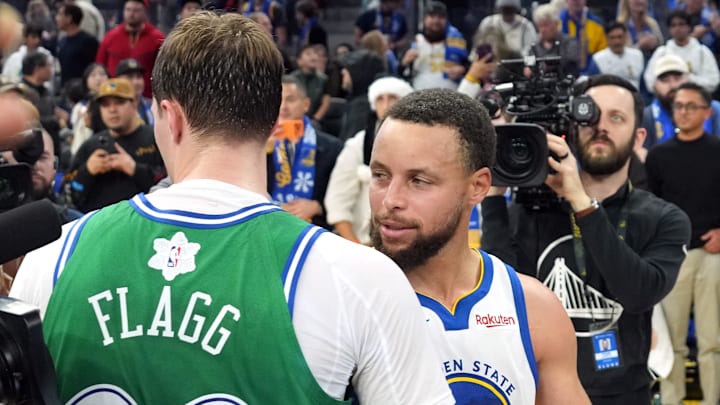 Dec 25, 2025; San Francisco, California, USA; Golden State Warriors guard Stephen Curry (30) and Dallas Mavericks forward Cooper Flagg (center left) greet each other after the game at Chase Center. Mandatory Credit: Darren Yamashita-Imagn Images