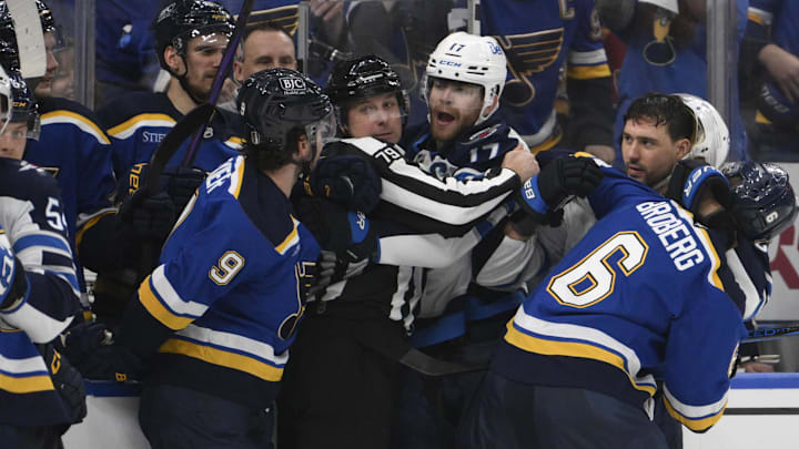 Apr 27, 2025; St. Louis, Missouri, USA; Winnipeg Jets center Adam Lowry (17) battles with St. Louis Blues left wing Alexandre Texier (9) during the third period in game four of the first round of the 2025 Stanley Cup Playoffs at Enterprise Center. Mandatory Credit: Jeff Le-Imagn Images