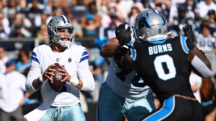Dallas Cowboys quarterback Dak Prescott looks to pass as Carolina Panthers linebacker Brian Burns pressures Dallas Cowboys quarterback Dak Prescott looks to pass as Carolina Panthers linebacker Brian Burns pressures