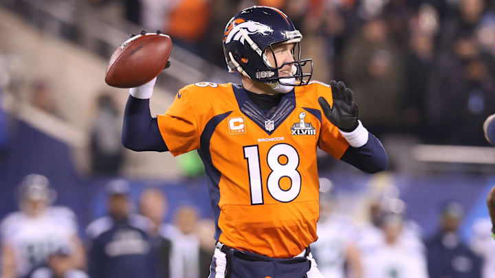 Feb 2, 2014; East Rutherford, NJ, USA; Denver Broncos quarterback Peyton Manning (18) throws in the pocket against the Seattle Seahawks in the fourth quarter in Super Bowl XLVIII at MetLife Stadium.  =
