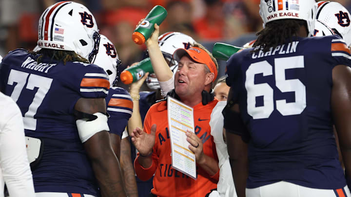 Oct 18, 2025; Auburn, Alabama, USA;  Auburn Tigers head coach Hugh Freeze talks with offensive lineman Jeremiah Wright (77) during the first quarter against the Missouri Tigers at Jordan-Hare Stadium. Mandatory Credit: John Reed-Imagn Images