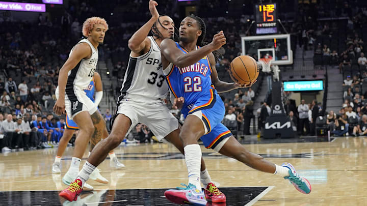 Oct 7, 2024; San Antonio, Texas, USA; Oklahoma City Thunder guard Cason Wallace (22) drives to the basket while defended by San Antonio Spurs guard Tre Jones (33) during the second half at Frost Bank Center. Mandatory Credit: Scott Wachter-Imagn Images Oct 7, 2024; San Antonio, Texas, USA; Oklahoma City Thunder guard Cason Wallace (22) drives to the basket while defended by San Antonio Spurs guard Tre Jones (33) during the second half at Frost Bank Center. Mandatory Credit: Scott Wachter-Imagn Images
