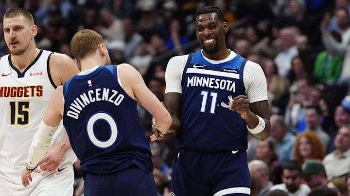 Mar 12, 2025; Denver, Colorado, USA; Minnesota Timberwolves center Naz Reid (11) celebrates his three point score with guard Donte DiVincenzo (0) in the second half against the Denver Nuggets at Ball Arena.