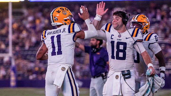 Sep 20, 2025; Baton Rouge, Louisiana, USA;  LSU Tigers quarterback Garrett Nussmeier (18) congratulates LSU Tigers quarterback Michael Van Buren Jr. (11) on a touchdown run against the Southeastern Louisiana Lions during the second half at Tiger Stadium. Mandatory Credit: Stephen Lew-Imagn Images