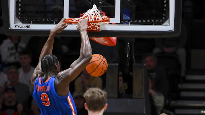 Jan 17, 2026; Nashville, Tennessee, USA;  Florida Gators center Rueben Chinyelu (9) dunks the ball against the Vanderbilt Commodores during the second half at Memorial Gymnasium.