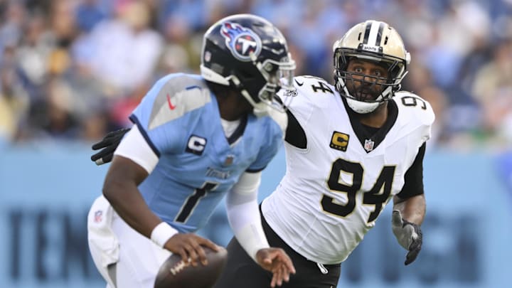 Dec 28, 2025; Nashville, Tennessee, USA;  New Orleans Saints defensive end Cameron Jordan (94) gives chase to Tennessee Titans quarterback Cam Ward (1) during the second half of the game at Nissan Stadium. Mandatory Credit: Steve Roberts-Imagn Images