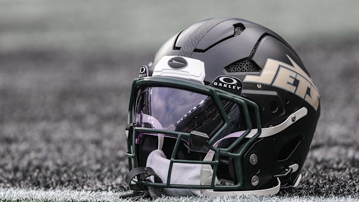 Dec 7, 2025; East Rutherford, New Jersey, USA; A general view of a Gotham City football rivalries helmet resting on the field before the game against the Miami Dolphins at MetLife Stadium. Mandatory Credit: Vincent Carchietta-Imagn Images