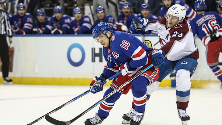 Dec 6, 2025; New York, New York, USA;  New York Rangers left wing Artemi Panarin (10) and Colorado Avalanche center Nathan MacKinnon (29) battle for control of the puck in the second period at Madison Square Garden. Mandatory Credit: Wendell Cruz-Imagn Images