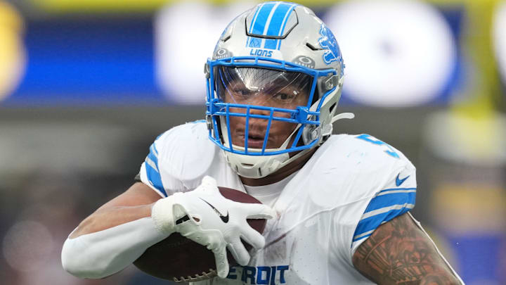 Dec 14, 2025; Inglewood, California, USA; Detroit Lions running back David Montgomery (5) runs the ball against Los Angeles Rams cornerback Emmanuel Forbes Jr. (1) during the second quarter at SoFi Stadium.