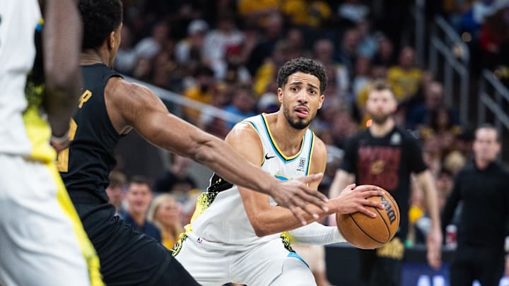 May 11, 2025; Indianapolis, Indiana, USA; Indiana Pacers guard Tyrese Haliburton (0) holds the ball while Cleveland Cavaliers forward De'Andre Hunter (12) defends during game four of the second round for the 2025 NBA Playoffs at Gainbridge Fieldhouse. Mandatory Credit: Trevor Ruszkowski-Imagn Images