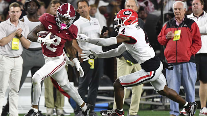 Alabama Crimson Tide wide receiver Ryan Williams (2) breaks a tackle by Georgia Bulldogs defensive back KJ Bolden (4)