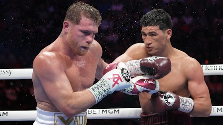 Canelo Alvarez (pink trunks) and Dmitry Bivol (black trunks) box during their light heavyweight championship bout at T-Mobile Arena. 