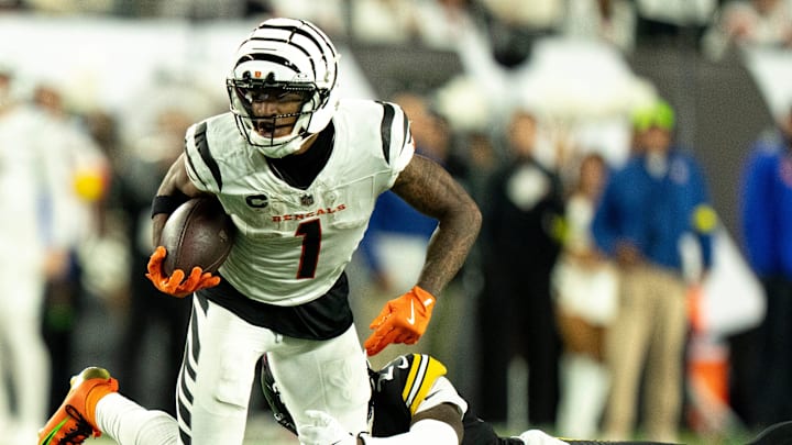 Cincinnati Bengals wide receiver Ja'Marr Chase (1) breaks a tackle attempt by Pittsburgh Steelers cornerback Joey Porter Jr. (24) in the fourth quarter of the NFL game between the Cincinnati Bengals and Pittsburgh Steelers at Paycor Stadium in Cincinnati on Oct. 16, 2025.