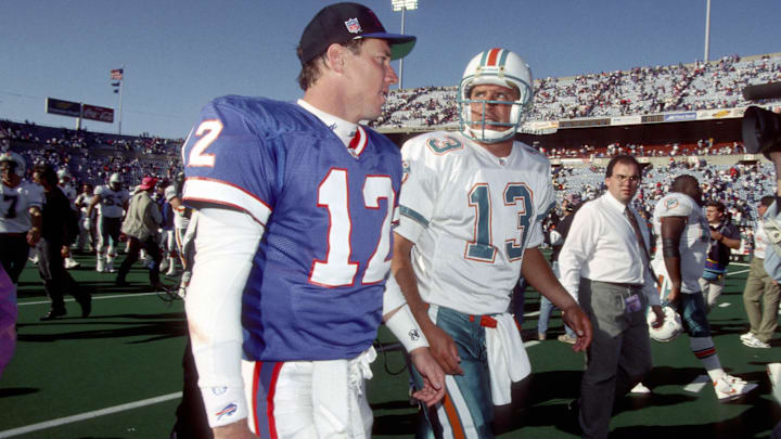 Buffalo Bills quarterback (12) Jim Kelly and Miami Dolphins quarterback Dan Marino (13) leave the field after the Dolphins defeated the Bills 37-10 at Rich Stadium. Buffalo Bills quarterback (12) Jim Kelly and Miami Dolphins quarterback Dan Marino (13) leave the field after the Dolphins defeated the Bills 37-10 at Rich Stadium.