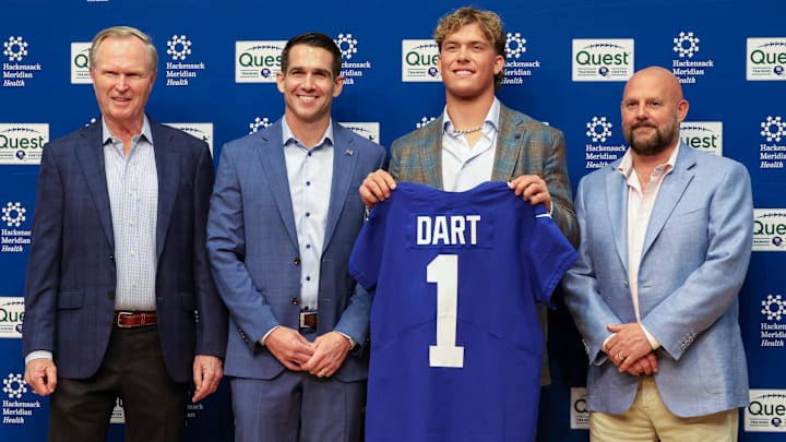 Apr 25, 2025; East Rutherford, NJ, US; New York Giants president John Mara (far left), general manager Joe Schoen (left), Jaxson Dart, and head coach Brian Daboll (right) pose for photos prior to the start of the press conference to introduce the Giants first round draft picks.  Mandatory Credit: Thomas Salus-Imagn Images