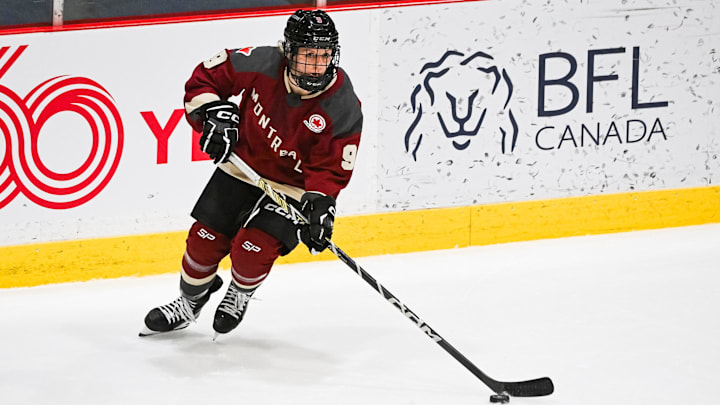 Jan 13, 2024; Montreal, Quebec, CANADA; Montreal defender Kati Tabin (9) plays the puck against Boston during the third period in a PWHL ice hockey game at Verdun Auditorium. Mandatory Credit: David Kirouac-Imagn Images