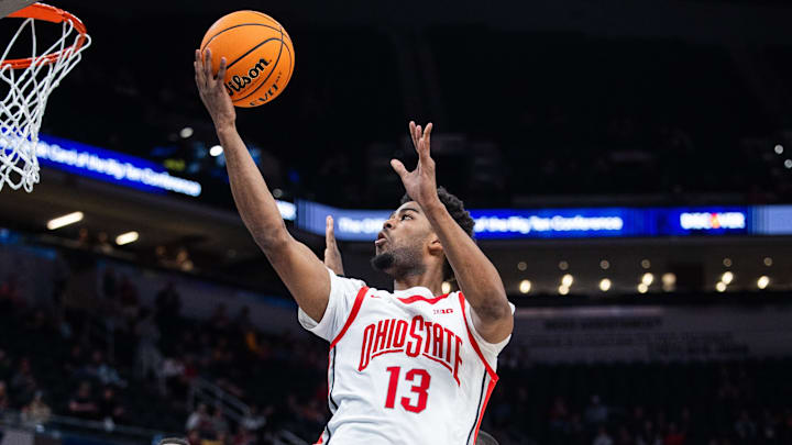 Mar 12, 2025; Indianapolis, IN, USA; Ohio State Buckeyes forward Sean Stewart (13) shoots the ball while Iowa Hawkeyes forward Ladji Dembele (13) defends in the second half  at Gainbridge Fieldhouse. Mandatory Credit: Trevor Ruszkowski-Imagn Images