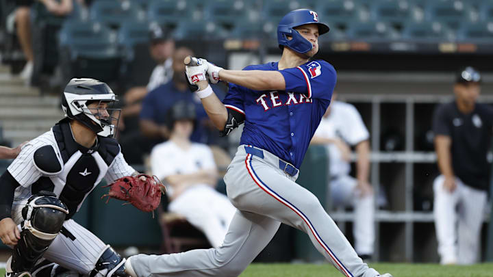 Aug 28, 2024; Chicago, IL, USA; Texas Rangers shortstop Corey Seager (5) hits an RBI-single against the Chicago White Sox during the seventh inning of game one of the doubleheader at Guaranteed Rate Field. 