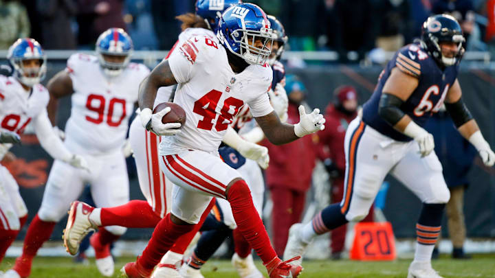 Jan 2, 2022; Chicago, Illinois, USA; New York Giants inside linebacker Tae Crowder (48) runs with the ball after making an interception against the Chicago Bears during the second half at Soldier Field. Mandatory Credit: Jon Durr-Imagn Images