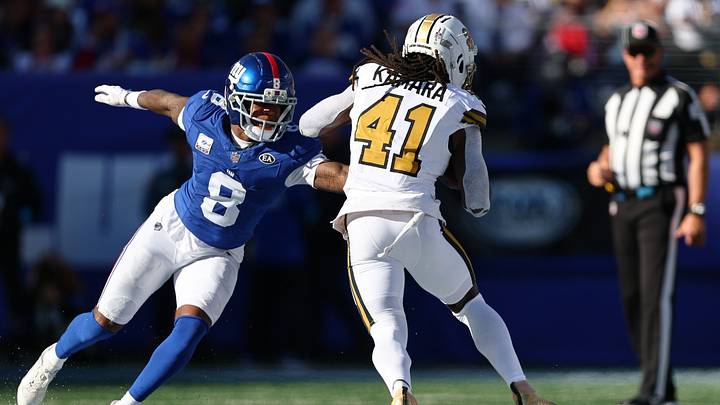 Oct 18, 2026; East Rutherford, New Jersey, USA;  New Orleans Saints running back Alvin Kamara (41) runs the ball against New York Giants safety Jevon Holland (8) during the third quarter at MetLife Stadium.  Mandatory Credit: Vincent Carchietta-Imagn Images