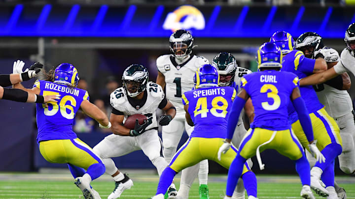 Nov 24, 2024; Inglewood, California, USA; Philadelphia Eagles running back Saquon Barkley (26) runs the ball against Los Angeles Rams linebacker Christian Rozeboom (56) and linebacker Omar Speights (48) during the first half at SoFi Stadium. Mandatory Credit: Gary A. Vasquez-Imagn Images Nov 24, 2024; Inglewood, California, USA; Philadelphia Eagles running back Saquon Barkley (26) runs the ball against Los Angeles Rams linebacker Christian Rozeboom (56) and linebacker Omar Speights (48) during the first half at SoFi Stadium. Mandatory Credit: Gary A. Vasquez-Imagn Images