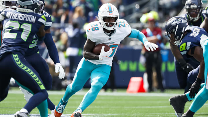 Sep 22, 2024; Seattle, Washington, USA; Miami Dolphins running back DeVon Achane (28) rushes against the Seattle Seahawks during the first quarter at Lumen Field. Mandatory Credit: Joe Nicholson-Imagn Images