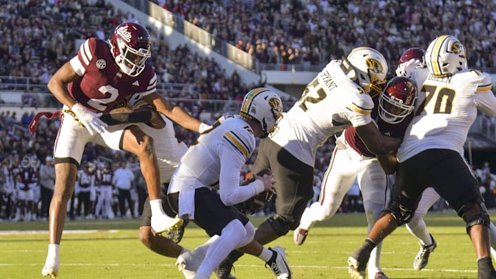 Nov 23, 2024; Starkville, Mississippi, USA;  Mississippi State Bulldogs safety Isaac Smith (2) sacks Missouri Tigers quarterback Brady Cook (12) during the first quarter at Davis Wade Stadium at Scott Field. Mandatory Credit: Matt Bush-Imagn Images