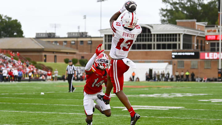 Nyziah Hunter leaps over Maryland Terrapins defensive back Jamare Glasker for a touchdown reception.