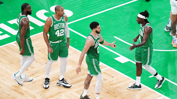 Jun 17, 2024; Boston, Massachusetts, USA; Boston Celtics forward Jayson Tatum (0) and guard Jrue Holiday (4) react in the second quarter against the Dallas Mavericks during game five of the 2024 NBA Finals at TD Garden. Mandatory Credit: David Butler II-Imagn Images
