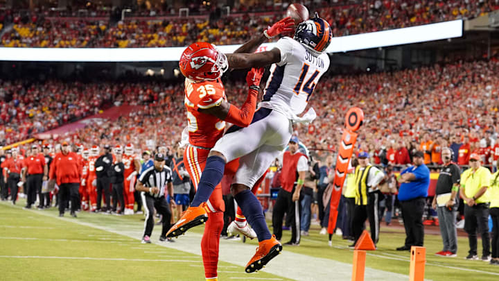 Oct 12, 2023; Kansas City, Missouri, USA; Denver Broncos wide receiver Courtland Sutton (14) catches a pass for a touchdown as Kansas City Chiefs cornerback Jaylen Watson (35) defends during the second half at GEHA Field at Arrowhead Stadium. 