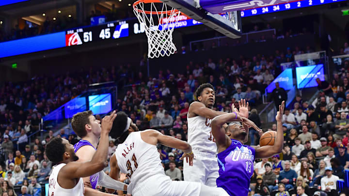 Mar 23, 2025; Salt Lake City, Utah, USA; Utah Jazz guard Isaiah Collier (13) gets blocked by Cleveland Cavaliers guard De'Andre Hunter (12) during the first half at Delta Center. Mandatory Credit: Peter Creveling-Imagn Images