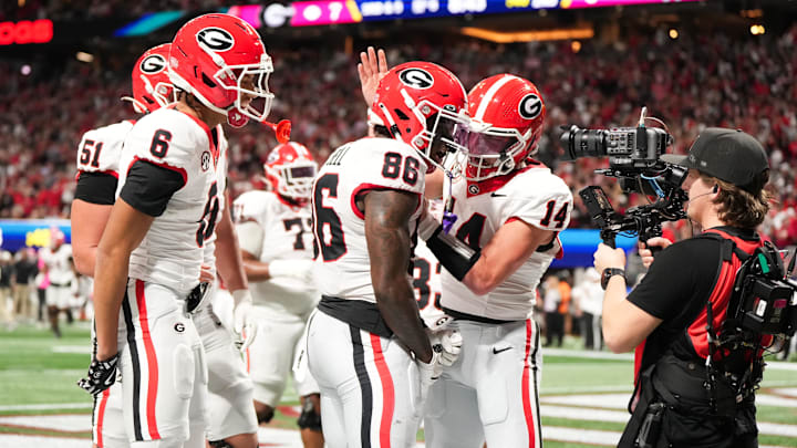 Dec 6, 2025; Atlanta, GA, USA; Georgia Bulldogs wide receiver Dillon Bell (86) celebrates with Georgia Bulldogs quarterback Gunner Stockton (14) after scoring a touchdown during the second quarter against the Alabama Crimson Tide during the 2025 SEC Championship game at Mercedes-Benz Stadium. Mandatory Credit: Dale Zanine-Imagn Images