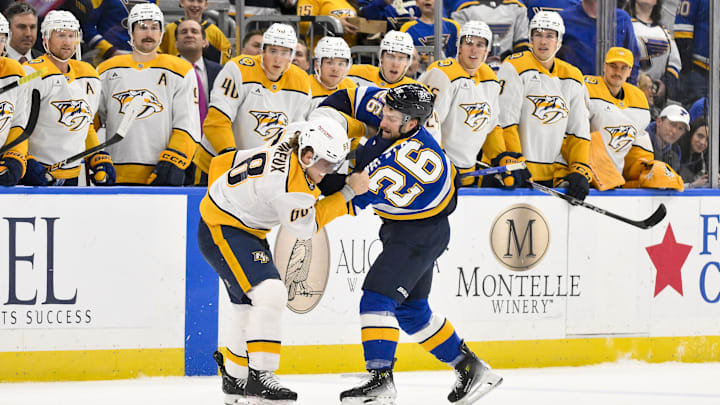 Mar 23, 2025; St. Louis, Missouri, USA;  St. Louis Blues left wing Nathan Walker (26) fights Nashville Predators left wing Zachary L'Heureux (68) during the first period at Enterprise Center. Mandatory Credit: Jeff Curry-Imagn Images