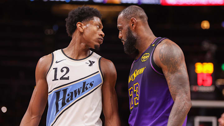 Dec 6, 2024; Atlanta, Georgia, USA; Atlanta Hawks forward De'Andre Hunter (12) is guarded by Los Angeles Lakers forward LeBron James (23) in the fourth quarter at State Farm Arena. Mandatory Credit: Brett Davis-Imagn Images

