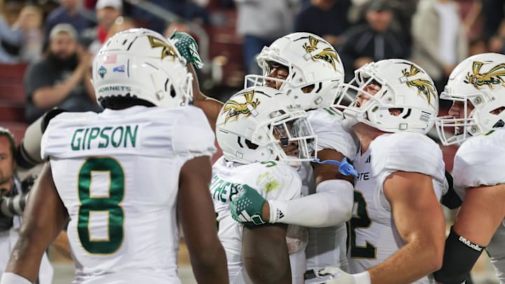 Sep 16, 2023; Stanford, California, USA; Sacramento State Hornets running back Marcus Fulcher (9) is congratulated by teammates after scoring a touchdown during the fourth quarter against the Stanford Cardinal at Stanford Stadium. Mandatory Credit: Sergio Estrada-Imagn Images