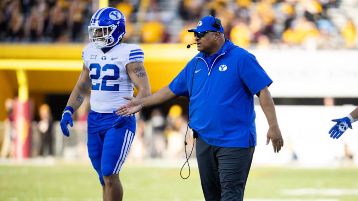Nov 23, 2024; Tempe, Arizona, USA; Brigham Young Cougars head coach Kalani Sitake with tight end Mason Fakahua (22) against the Arizona State Sun Devils at Mountain America Stadium. Mandatory Credit: Mark J. Rebilas-Imagn Images