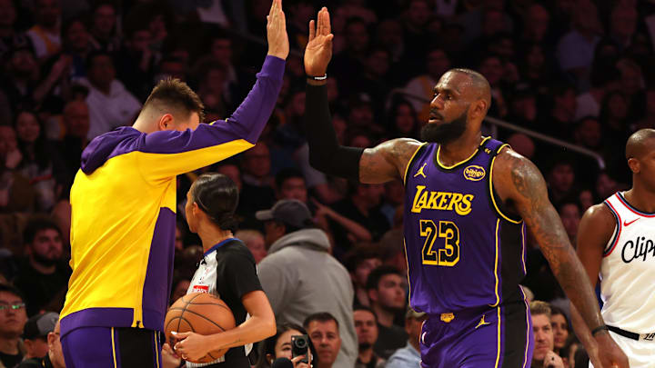 Feb 28, 2025; Los Angeles, California, USA; Los Angeles Lakers forward LeBron James (23) celebrates with guard Luka Doncic (77) during the second quarter against the LA Clippers at Crypto.com Arena. Mandatory Credit: Jason Parkhurst-Imagn Images