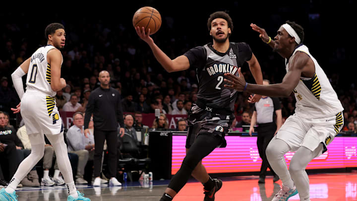 Dec 4, 2024; Brooklyn, New York, USA; Brooklyn Nets forward Cameron Johnson (2) drives to the basket against Indiana Pacers forward Pascal Siakam (43) and guard Tyrese Haliburton (0) during the fourth quarter at Barclays Center. Mandatory Credit: Brad Penner-Imagn Images
