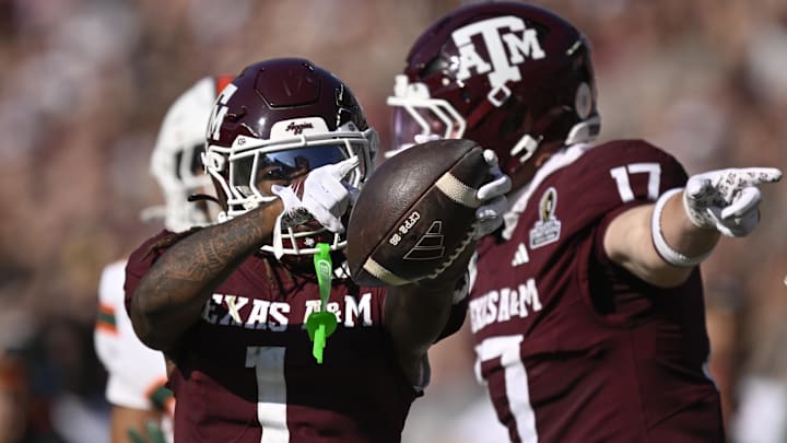 Dec 20, 2025; College Station, TX, USA; Texas A&M Aggies wide receiver Mario Craver (1) and Texas A&M Aggies tight end Theo Melin Öhrström (17) celebrate a first down against the Miami Hurricanes during the second half of the first round game of the CFP National Playoff at Kyle Field. Mandatory Credit: Jerome Miron-Imagn Images