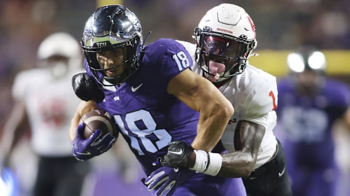 Oct 4, 2024; Fort Worth, Texas, USA; TCU Horned Frogs wide receiver Jack Bech (18) breaks the tackle of Houston Cougars defensive back Latrell McCutchin Sr. (1) and scores a touchdown in the fourth quarter at Amon G. Carter Stadium. Mandatory Credit: Tim Heitman-Imagn Images Oct 4, 2024; Fort Worth, Texas, USA; TCU Horned Frogs wide receiver Jack Bech (18) breaks the tackle of Houston Cougars defensive back Latrell McCutchin Sr. (1) and scores a touchdown in the fourth quarter at Amon G. Carter Stadium. Mandatory Credit: Tim Heitman-Imagn Images