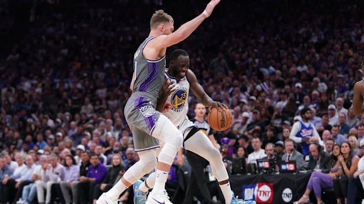 Apr 26, 2023; Sacramento, California, USA; Golden State Warriors forward Draymond Green (23) is defended by Sacramento Kings center Domantas Sabonis (10).