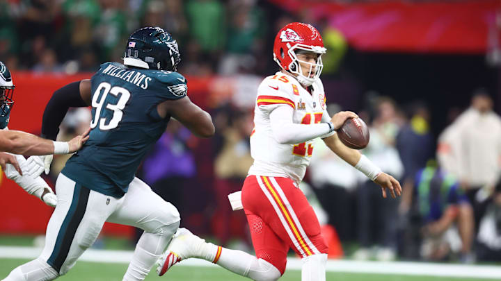 Feb 9, 2025; New Orleans, LA, USA; Kansas City Chiefs quarterback Patrick Mahomes (15) runs away from Philadelphia Eagles defensive tackle Milton Williams (93) in the third quarter in Super Bowl LIX at Ceasars Superdome. Mandatory Credit: Mark J. Rebilas-Imagn Images