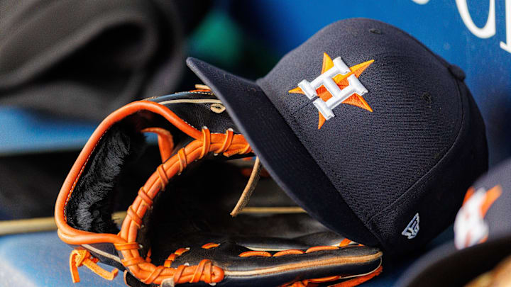 Apr 27, 2025; Kansas City, Missouri, USA; Houston Astros hat and glove in the dugout during the second inning against the Kansas City Royals at Kauffman Stadium. Mandatory Credit: William Purnell-Imagn Images