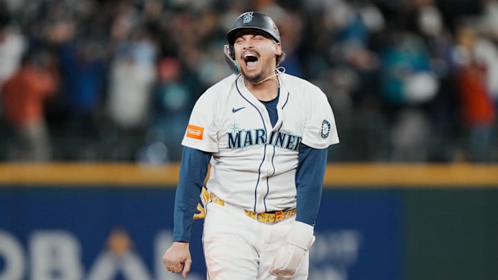Oct 17, 2025; Seattle, Washington, USA; Seattle Mariners first baseman Josh Naylor (12) reacts after third baseman Eugenio Suarez (not pictured) hits a grand slam against the Toronto Blue Jays in the eighth inning during game five of the ALCS round for the 2025 MLB playoffs at T-Mobile Park. Mandatory Credit: Stephen Brashear-Imagn Images Oct 17, 2025; Seattle, Washington, USA; Seattle Mariners first baseman Josh Naylor (12) reacts after third baseman Eugenio Suarez (not pictured) hits a grand slam against the Toronto Blue Jays in the eighth inning during game five of the ALCS round for the 2025 MLB playoffs at T-Mobile Park. Mandatory Credit: Stephen Brashear-Imagn Images